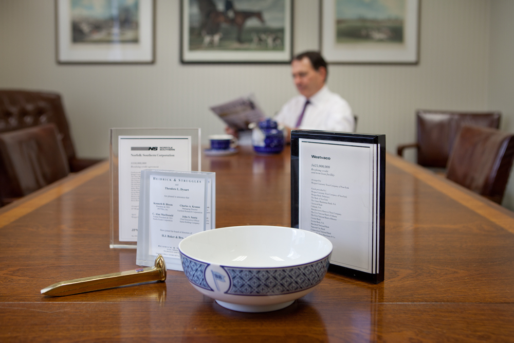 A bowl on the table in front of a man.